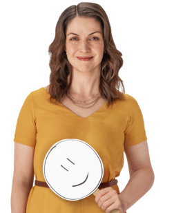 Female REXULTI user smiling while holding smiley face sign.