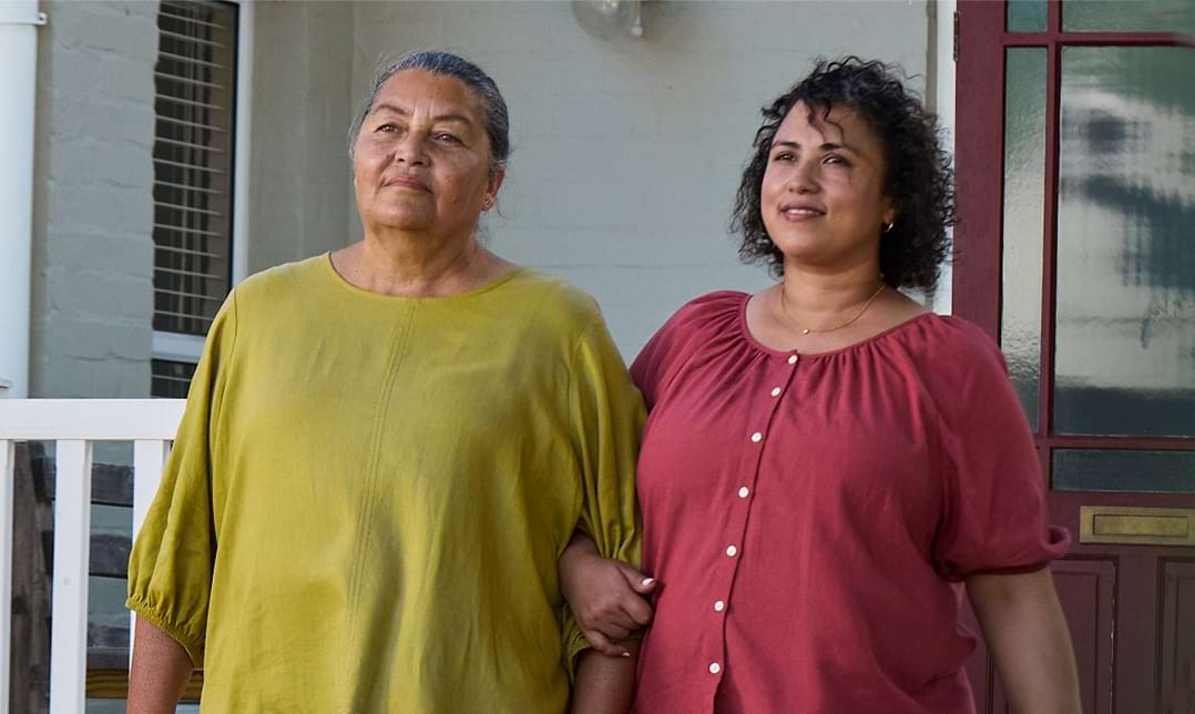 Actor portrayal of adult daughter walking outsite alongside her elderly mother with agitation that may happen with dementia due to Alzheimer's disease.