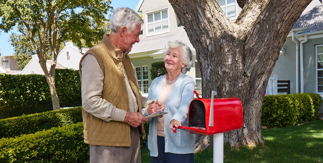 Actor portrayal of elderly man checking the mailbox with his wife with agitation that may happen with dementia due to Alzheimer's disease.