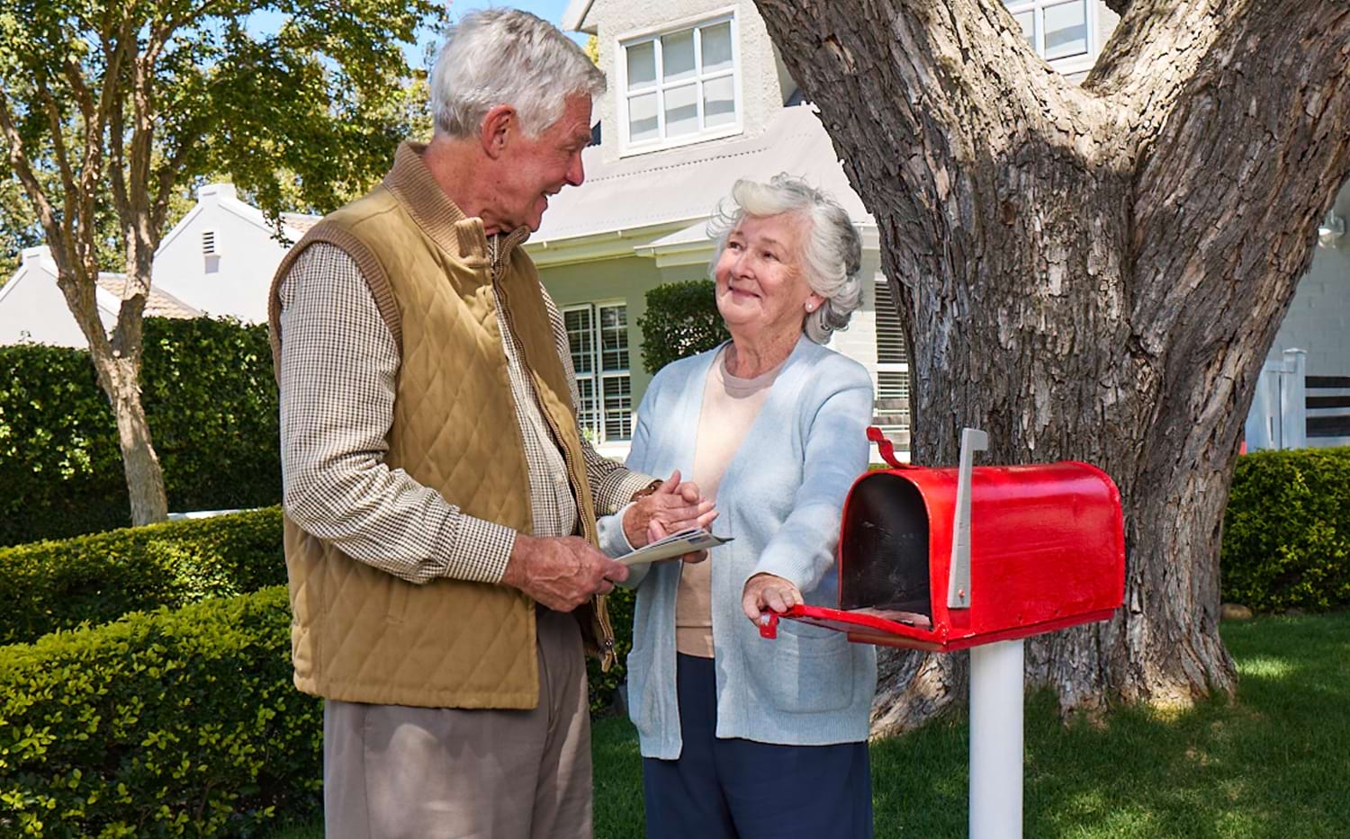 Actor portrayal of elderly man checking the mailbox with his wife with agitation that may happen with dementia due to Alzheimer's disease.