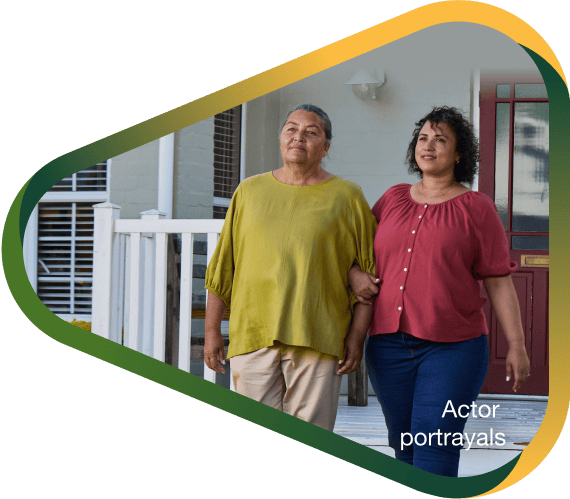 Actor portrayal of adult daughter walking outsite alongside her elderly mother with agitation that may happen with dementia due to Alzheimer's disease.