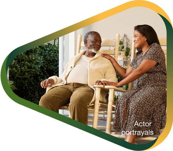 Actor portrayal of adult daughter sitting peacefully on the porch with her elderly father with agitation that may happen with dementia due to Alzheimer's disease.