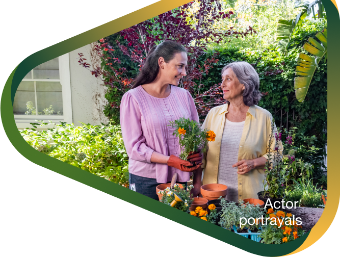 Actor portrayal of adult daughter potting flowers with elderly mother in her backyard, who has agitation that may happen with dementia due to Alzheimer's disease.