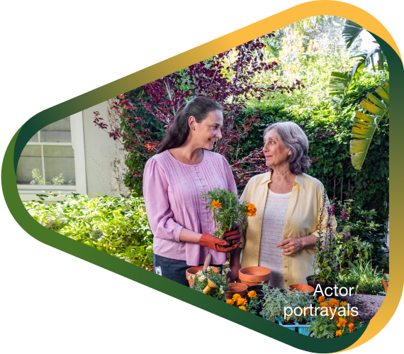 Actor portrayal of adult daughter potting flowers with elderly mother in her backyard, who has agitation that may happen with dementia due to Alzheimer's disease.