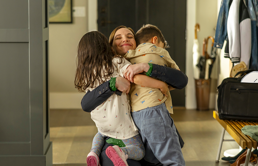 REXULTI for depression user hugging her children after arriving home from work
