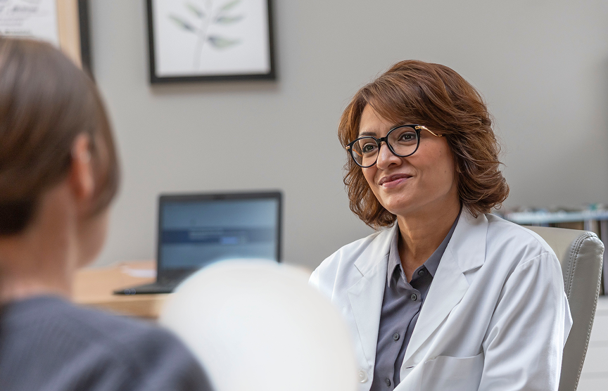 REXULTI for depression user having a positive conversation with her doctor in her office